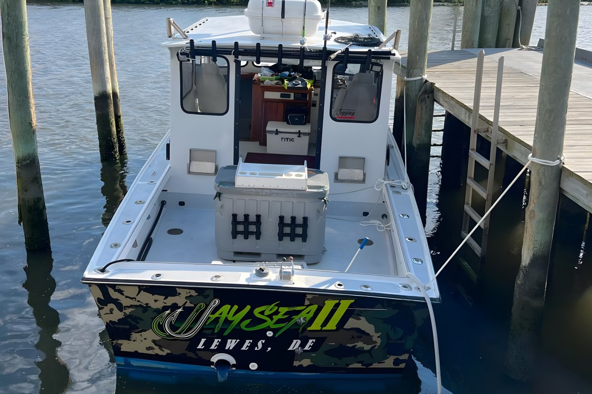 A small boat moored at a dock, named JaySea II, with fishing gear on board.